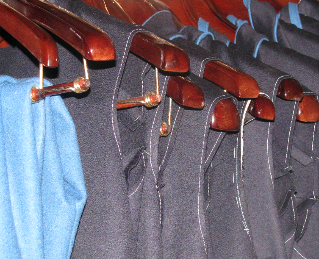 Coats hanging on hangers in progress.