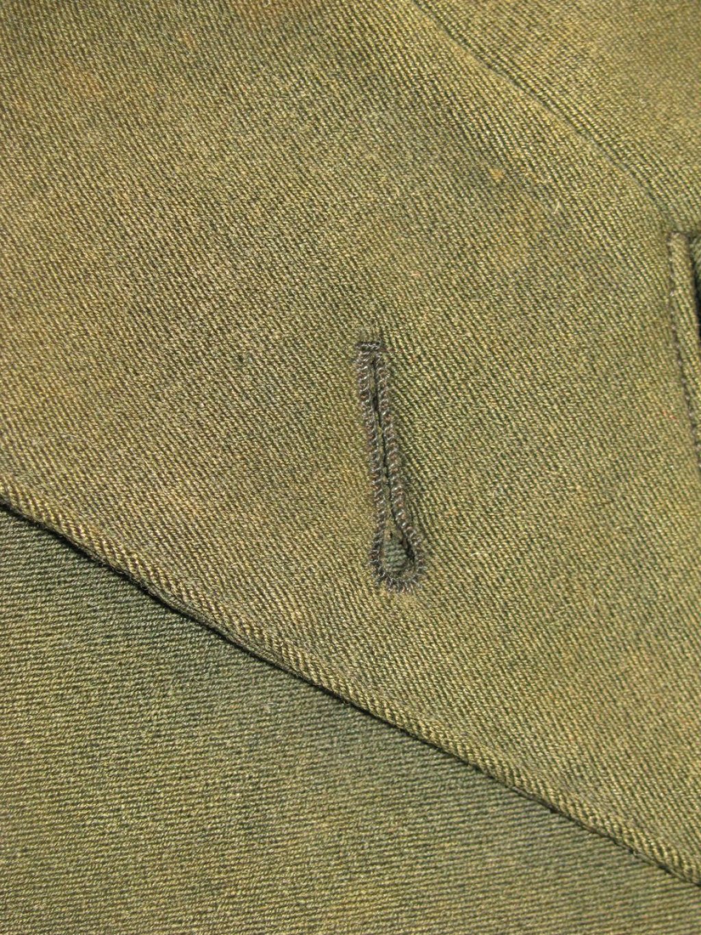 Early 20th century buttonhole in green wool.